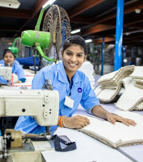 Factory workers sewing fabric together