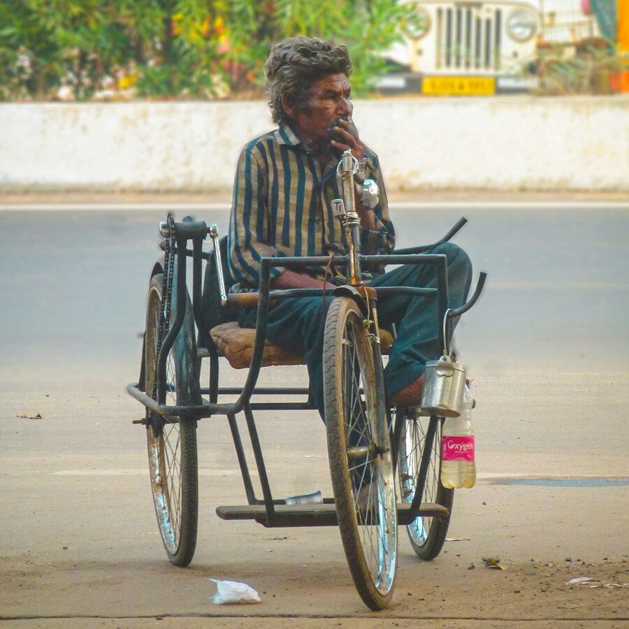 a man in a wheelchair smoking a cigarette