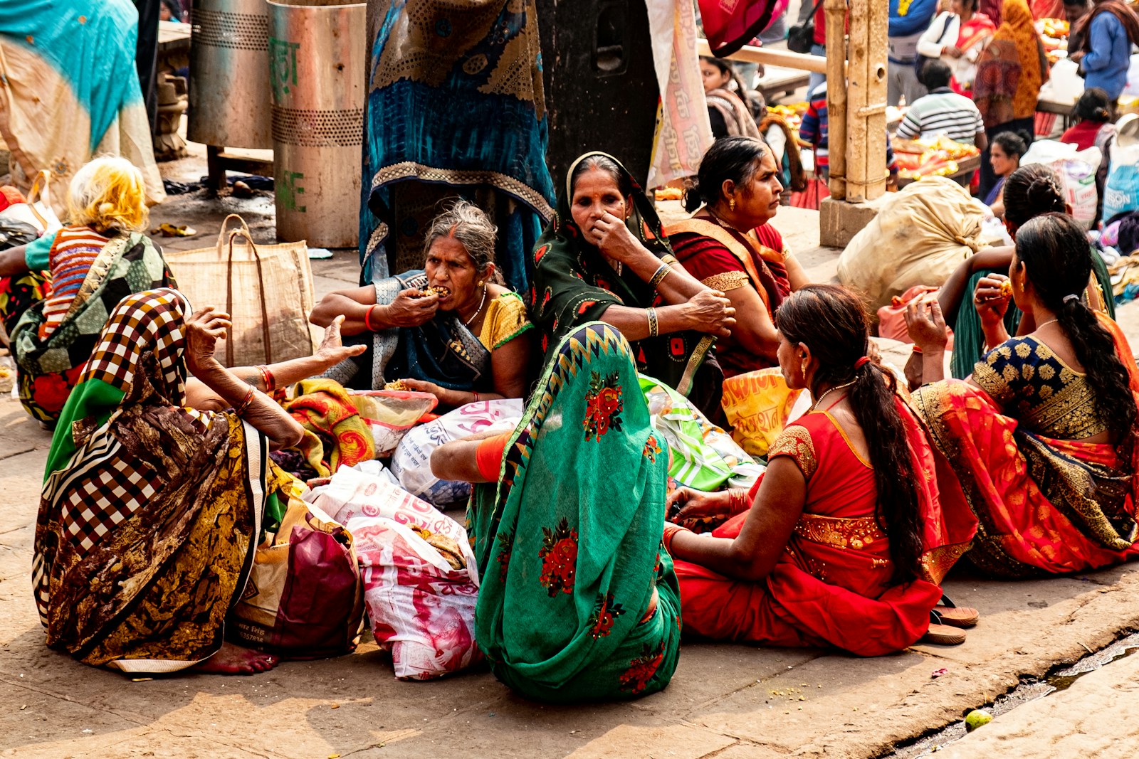 Photo by Antoine Bernardini a group of women sitting next to each other